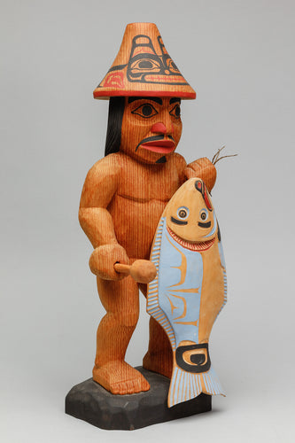 Carving depicting Fisherman with Halibut by Lelooska (1933-1996)