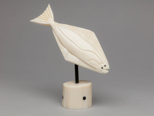 Carving depicting Diving Halibut by Kyle Pungowiyi, Inupiaq