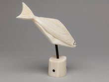 Carving depicting Diving Halibut by Kyle Pungowiyi, Inupiaq